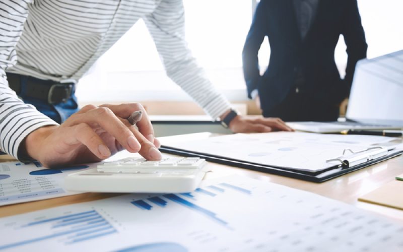 two Business executives partner analysis data document with accountant at office place